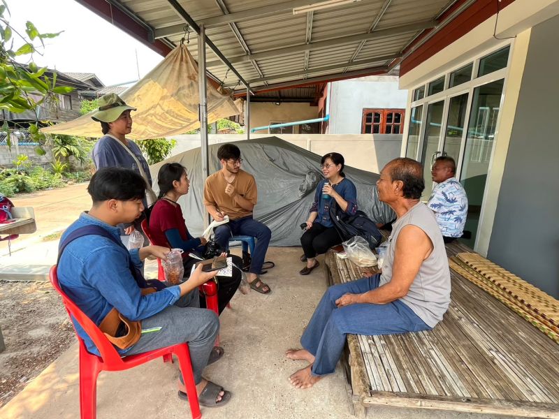 researchers sitting in a circle, interviewing local respondents