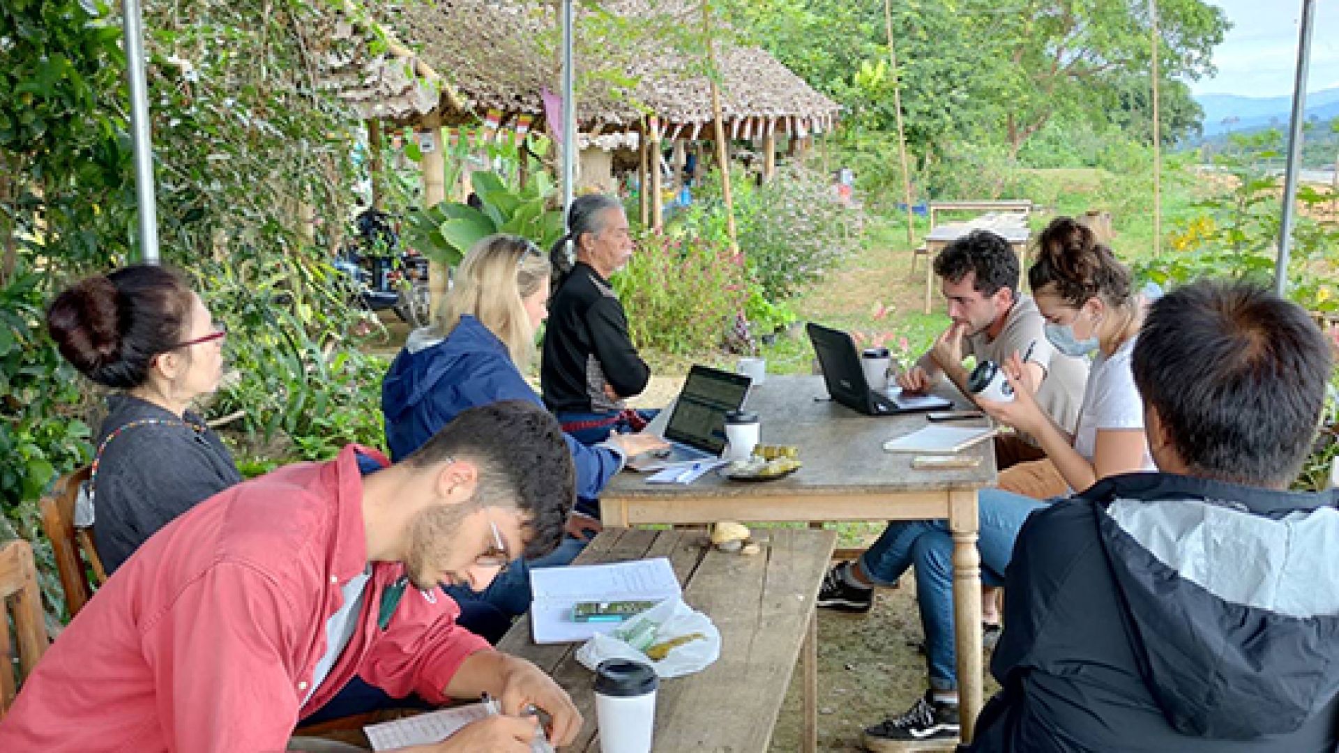 Students meeting with local stakeholders on the banks of the Mekong River